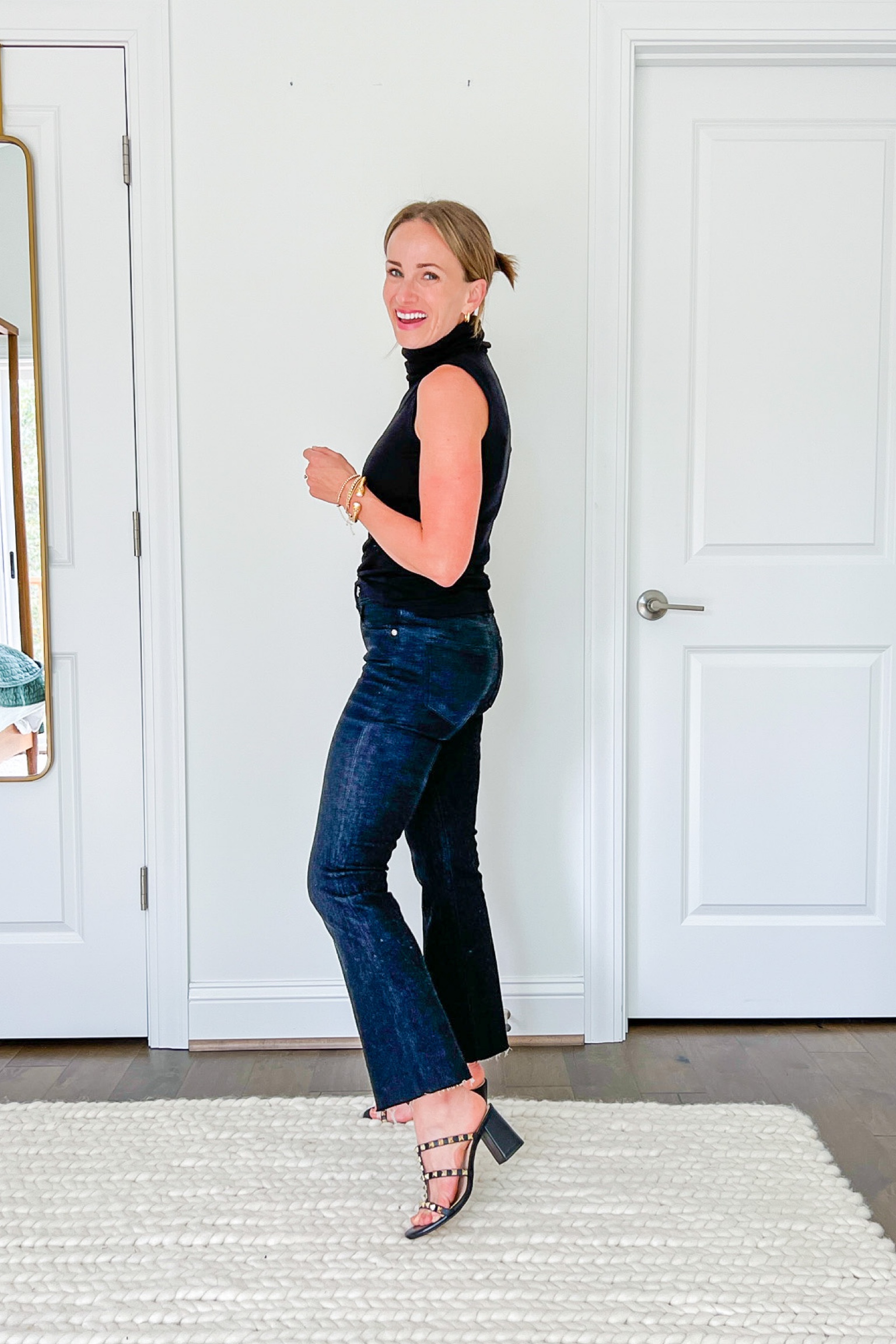 sleeveless turtleneck sweater outfit sleeveless turtleneck sweater paired with cropped black jeans and studded black heels #LTKunder100#LTKshoecrush#LTKSeasonal #LTKCon